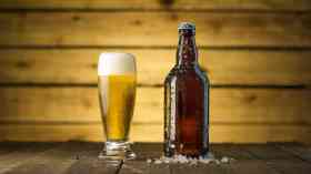 A glass and a bottle of beer